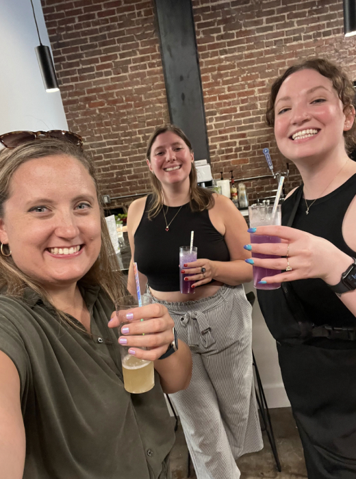 three people with drinks at the Few HQ opening party